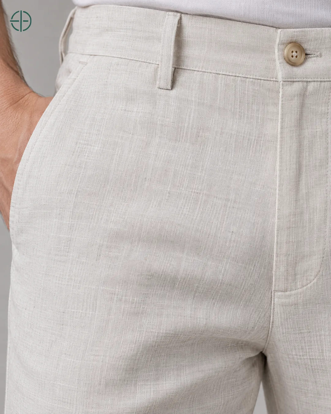 Calça 100% Linho Belga Masculina, cor Branco, macro do produto no modelo, em estúdio profissional com fundo cinza ostra.