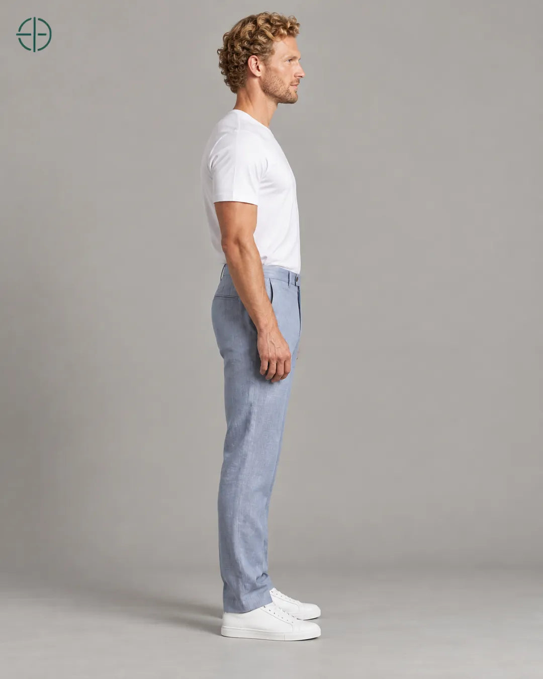 Calça 100% Linho Belga Masculina, cor Azul Claro, mesmo modelo e roupa de lado, em estúdio profissional com fundo cinza ostra.